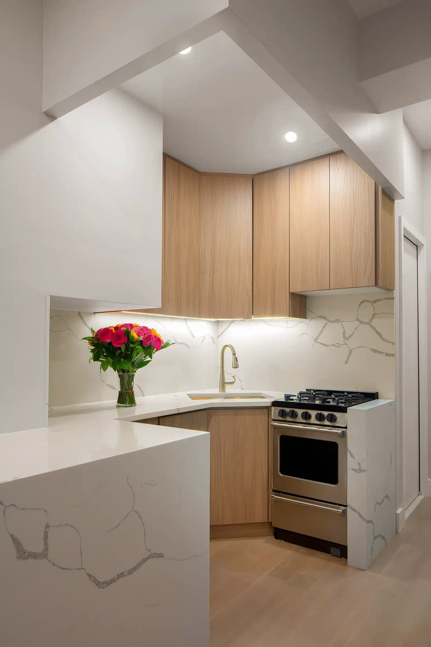 Renovated modern kitchen with marble and wood cabinets